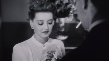 Movie still from “Summer of '42” (1971), directed by Robert Mulligan – An old black and white photo of a woman smoking a cigarette; Close Up shot, High angle