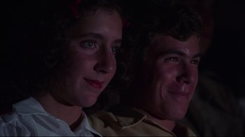 Movie still from “Summer of '42” (1971), directed by Robert Mulligan – A man and a woman sitting next to each other in the dark; Close Up shot, Low angle