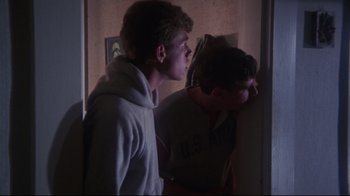 Movie still from “Summer of '42” (1971), directed by Robert Mulligan – Two young men standing next to each other in front of a wall; Close Up shot, Low angle