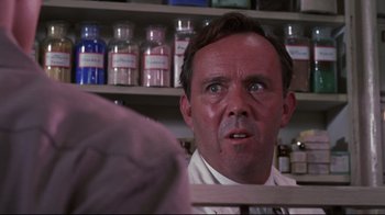 Movie still from “Summer of '42” (1971), directed by Robert Mulligan – A man in a lab coat is looking at the camera; Close Up shot, Low angle