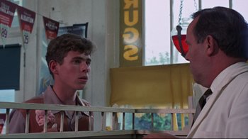 Movie still from “Summer of '42” (1971), directed by Robert Mulligan – A man and a woman talking to each other in front of a window; Medium shot, Over the shoulder angle