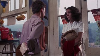 Movie still from “Summer of '42” (1971), directed by Robert Mulligan – Two people standing in front of a door; Medium shot, Over the shoulder angle