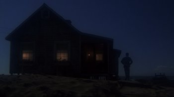 Movie still from “Summer of '42” (1971), directed by Robert Mulligan – A person standing in front of a house at night; Extreme Wide shot, Low angle