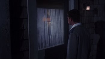 Movie still from “Summer of '42” (1971), directed by Robert Mulligan – A man standing in front of a window; Medium shot, Over the shoulder angle