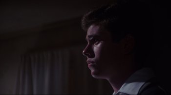 Movie still from “Summer of '42” (1971), directed by Robert Mulligan – A young man looking up into the light; Close Up shot, Over the shoulder angle