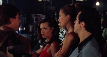 Movie still from “Summer of Sam” (1999), directed by Spike Lee – A group of people sitting next to each other in a room; Medium shot, Over the shoulder angle