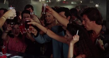 Movie still from “Summer of Sam” (1999), directed by Spike Lee – A group of young people holding drinks in their hands; Medium shot, Overhead angle