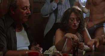 Movie still from “Summer of Sam” (1999), directed by Spike Lee – A man and a woman sitting at a dinner table; Medium shot, Over the shoulder angle