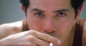 Movie still from “Summer of Sam” (1999), directed by Spike Lee – A person with his hand over his mouth; Extreme Close Up shot, Low angle
