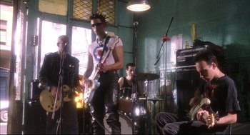 Movie still from “Summer of Sam” (1999), directed by Spike Lee – A group of people that are playing music together; Wide shot, Low angle