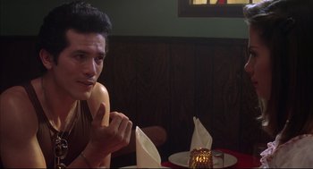 Movie still from “Summer of Sam” (1999), directed by Spike Lee – A man sitting in front of a table in a restaurant; Close Up shot, Over the shoulder angle