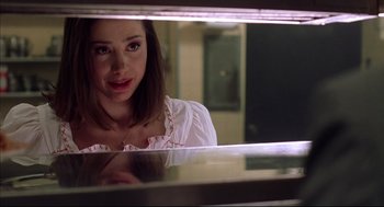 Movie still from “Summer of Sam” (1999), directed by Spike Lee – A woman looking at her reflection in a mirror; Close Up shot, Over the shoulder angle