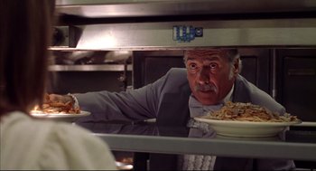 Movie still from “Summer of Sam” (1999), directed by Spike Lee – A man in a kitchen holding a plate of pasta; Close Up shot, Low angle