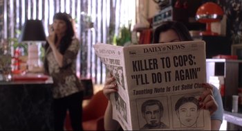 Movie still from “Summer of Sam” (1999), directed by Spike Lee – A person reading a newspaper in a living room; Medium shot, High angle