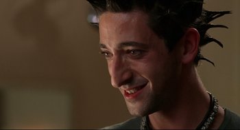 Movie still from “Summer of Sam” (1999), directed by Spike Lee – A man smiling for the camera; Close Up shot, Low angle