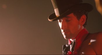 Movie still from “Summer of Sam” (1999), directed by Spike Lee – A person wearing a top hat; Close Up shot, Low angle