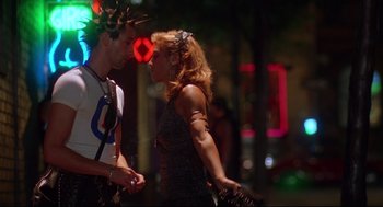 Movie still from “Summer of Sam” (1999), directed by Spike Lee – A man and a woman standing next to each other on the street; Medium shot, Over the shoulder angle