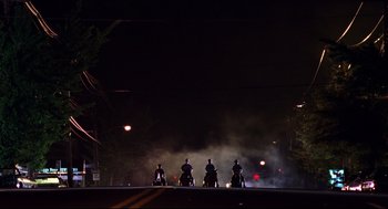 Movie still from “Summer of Sam” (1999), directed by Spike Lee – A group of people riding horses down a street; Extreme Wide shot, Low angle