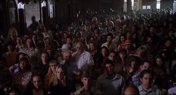 Movie still from “Summer of Sam” (1999), directed by Spike Lee – A large group of people gathered together in a room; Wide shot, High angle
