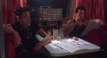 Movie still from “Summer of Sam” (1999), directed by Spike Lee – Two men sitting at a table in front of a computer; Medium shot, Over the shoulder angle