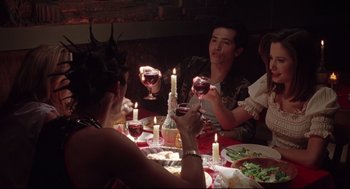 Movie still from “Summer of Sam” (1999), directed by Spike Lee – A group of people sitting around a table with wine glasses; Medium shot, High angle