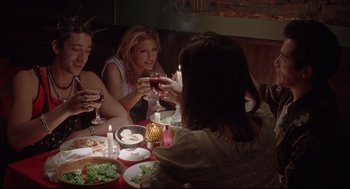 Movie still from “Summer of Sam” (1999), directed by Spike Lee – A group of people sitting around a table with food; Medium shot, High angle