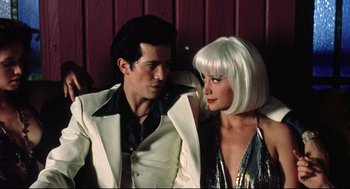 Movie still from “Summer of Sam” (1999), directed by Spike Lee – A man and a woman dressed in white and wearing a white wig; Medium shot, Low angle