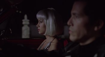 Movie still from “Summer of Sam” (1999), directed by Spike Lee – A man and a woman sitting next to each other; Close Up shot, Over the shoulder angle