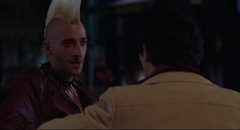 Movie still from “Summer of Sam” (1999), directed by Spike Lee – A man with a white mohawk is talking to another man; Close Up shot, Over the shoulder angle