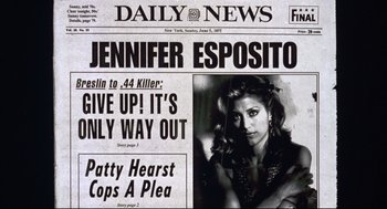 Movie still from “Summer of Sam” (1999), directed by Spike Lee – A black and white photo of a newspaper with a picture of jennifer esposito on it; Close Up shot, Low angle