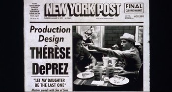 Movie still from “Summer of Sam” (1999), directed by Spike Lee – Two people sitting at a dinner table in front of a new york post newspaper; Extreme Close Up shot, High angle