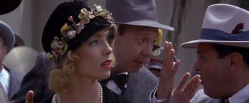 Movie still from “Sunset” (1988), directed by Blake Edwards – A man and a woman wearing hats and a dress; Close Up shot, Over the shoulder angle