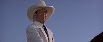 Movie still from “Sunset” (1988), directed by Blake Edwards – A man in a white suit and a white cowboy hat; Close Up shot, Low angle