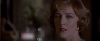 Movie still from “Sunset” (1988), directed by Blake Edwards – A woman's face in front of a blurry background; Close Up shot, Over the shoulder angle