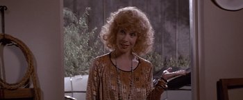 Movie still from “Sunset” (1988), directed by Blake Edwards – A person wearing a dress; Close Up shot, Over the shoulder angle