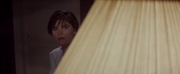 Movie still from “Sunset” (1988), directed by Blake Edwards – A woman looking in the mirror in front of a mirror; Close Up shot, High angle