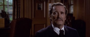 Movie still from “Sunset” (1988), directed by Blake Edwards – A man in a suit and tie; Close Up shot, Over the shoulder angle