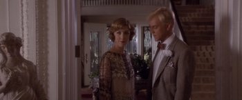 Movie still from “Sunset” (1988), directed by Blake Edwards – A man and a woman standing next to each other in a room; Medium shot, Low angle