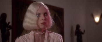 Movie still from “Sunset” (1988), directed by Blake Edwards – A woman with blonde hair wearing a pink dress; Close Up shot, Low angle