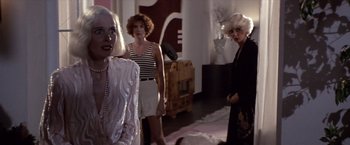 Movie still from “Sunset” (1988), directed by Blake Edwards – A group of women standing next to each other in a room; Medium shot, Over the shoulder angle