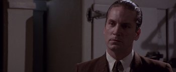 Movie still from “Sunset” (1988), directed by Blake Edwards – A man in a suit and a tie; Close Up shot, Low angle