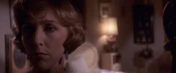 Movie still from “Sunset” (1988), directed by Blake Edwards – A person with a phone in her ear; Close Up shot, Over the shoulder angle