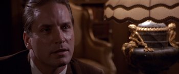 Movie still from “Sunset” (1988), directed by Blake Edwards – A man that is looking at the camera; Close Up shot, Over the shoulder angle