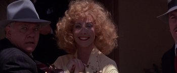 Movie still from “Sunset” (1988), directed by Blake Edwards – A person wearing a yellow shirt; Close Up shot, Low angle