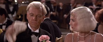 Movie still from “Sunset” (1988), directed by Blake Edwards – A man and a woman sitting in front of a crowd; Close Up shot, Over the shoulder angle