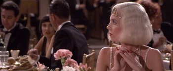 Movie still from “Sunset” (1988), directed by Blake Edwards – A woman sitting at a dinner table wearing a tiara; Close Up shot, Over the shoulder angle