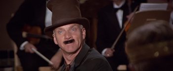 Movie still from “Sunset” (1988), directed by Blake Edwards – A man with a mustache wearing a top hat; Close Up shot, Low angle