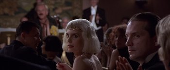 Movie still from “Sunset” (1988), directed by Blake Edwards – A woman in a white wig and a gold headpiece; Close Up shot, Over the shoulder angle