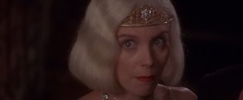 Movie still from “Sunset” (1988), directed by Blake Edwards – A person wearing a tiara; Close Up shot, Over the shoulder angle