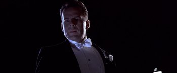 Movie still from “Sunset” (1988), directed by Blake Edwards – A man wearing a tuxedo and a white bow tie; Close Up shot, Low angle